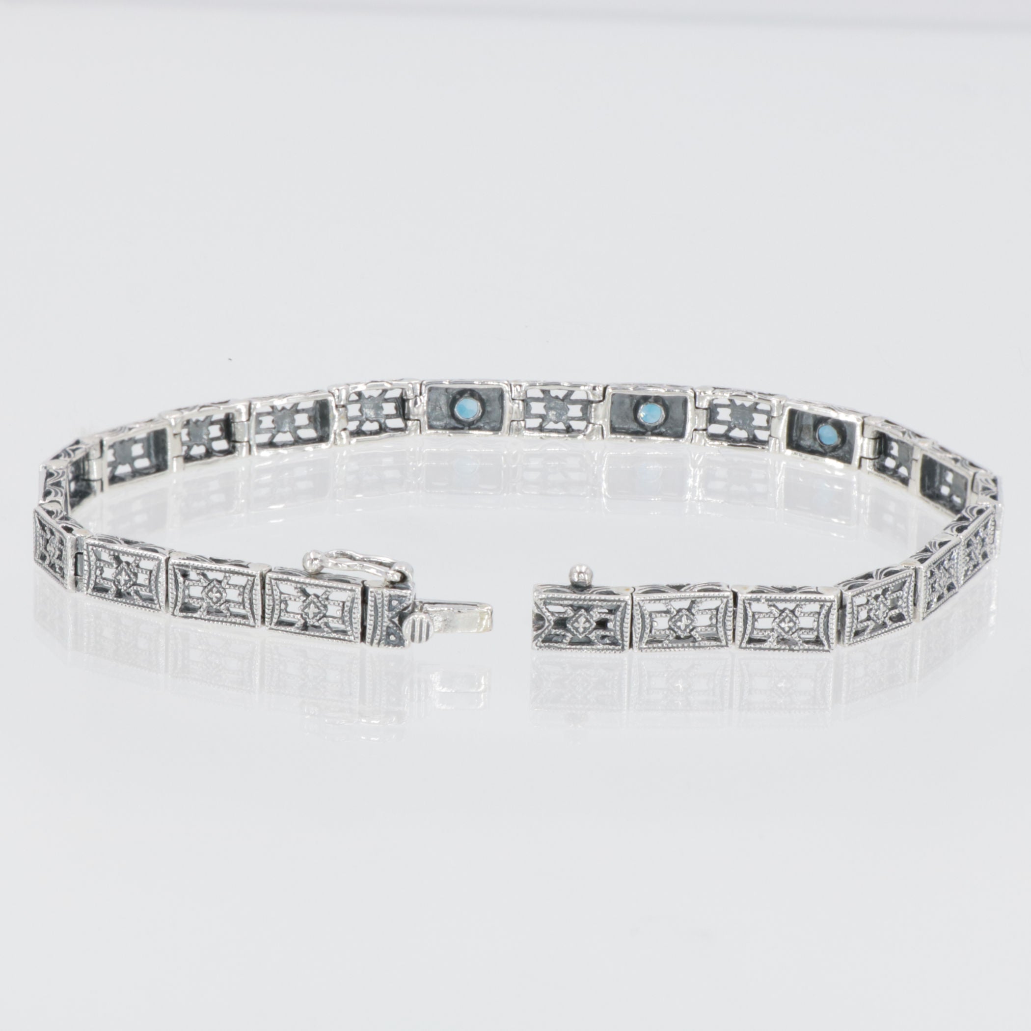 Back view of 7 1/4 inch Victorian Style 3 Stone London Blue Topaz Filigree Bracelet in Fine Sterling Silver showing 925 sterl