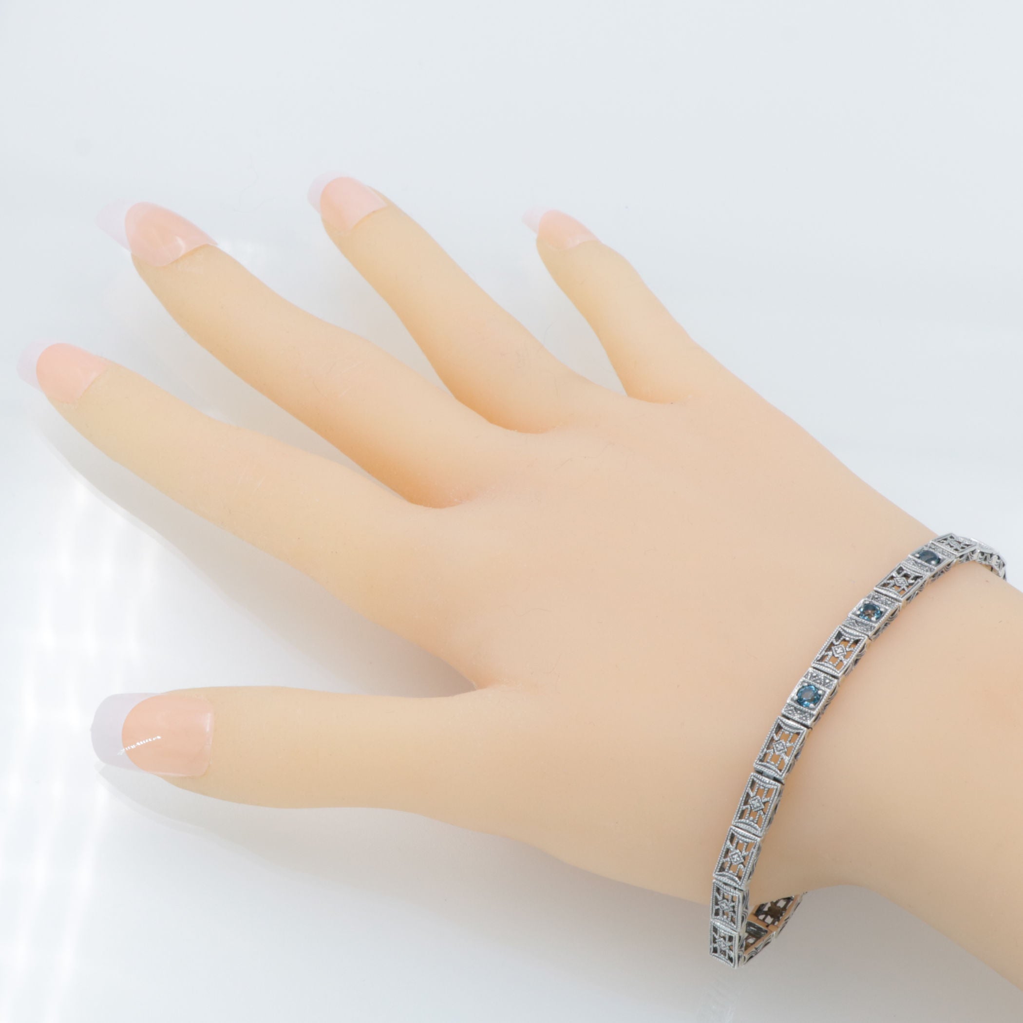 Detail view of 7 1/4 inch Victorian Style 3 Stone London Blue Topaz Filigree Bracelet in Fine Sterling Silver highlighting Bl