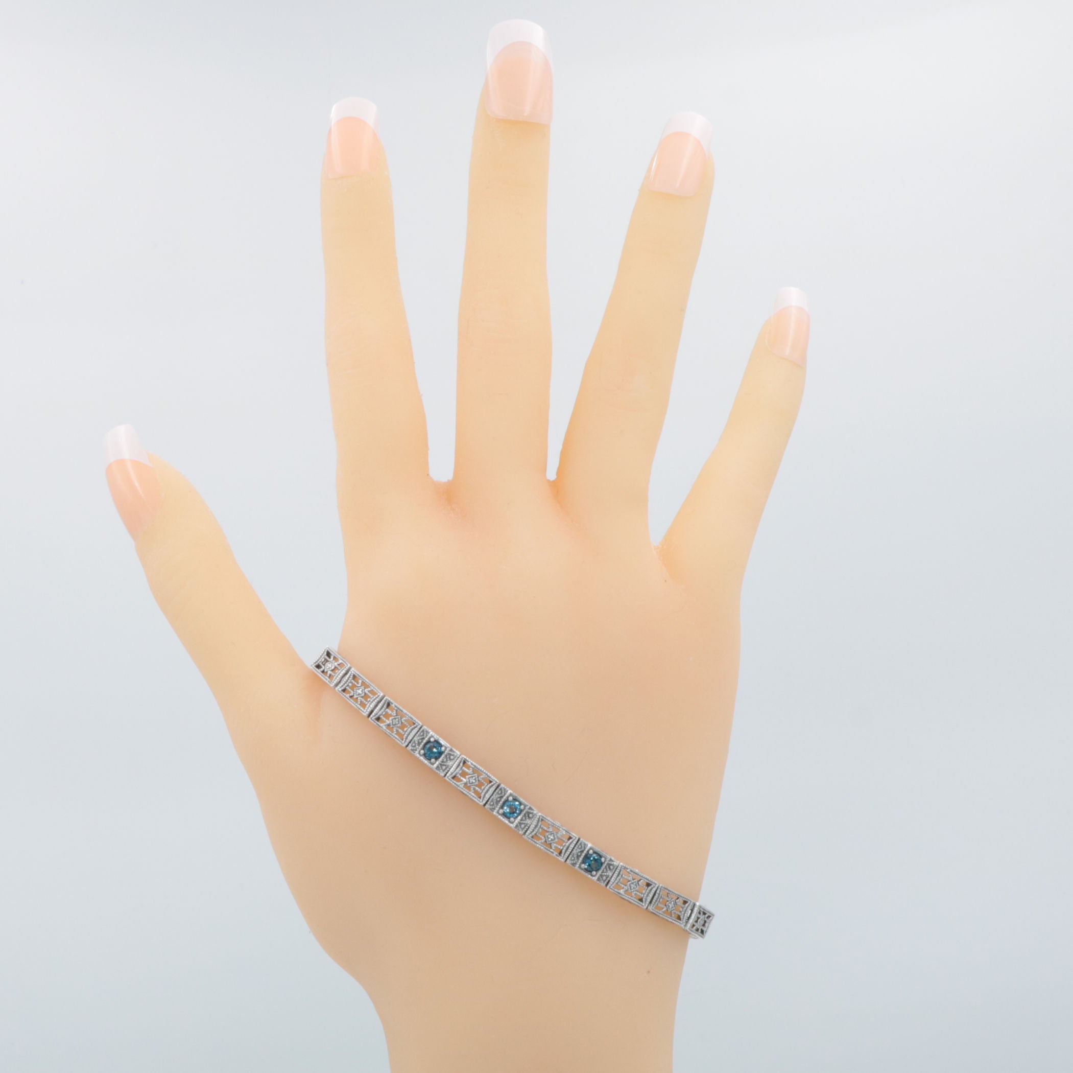 Detail view of 7 1/4 inch Victorian Style 3 Stone London Blue Topaz Filigree Bracelet in Fine Sterling Silver highlighting Bl