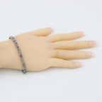 Detail view of Victorian Style 3 Stone Natural Red Ruby Filigree Bracelet in Fine Sterling Silver highlighting Ruby