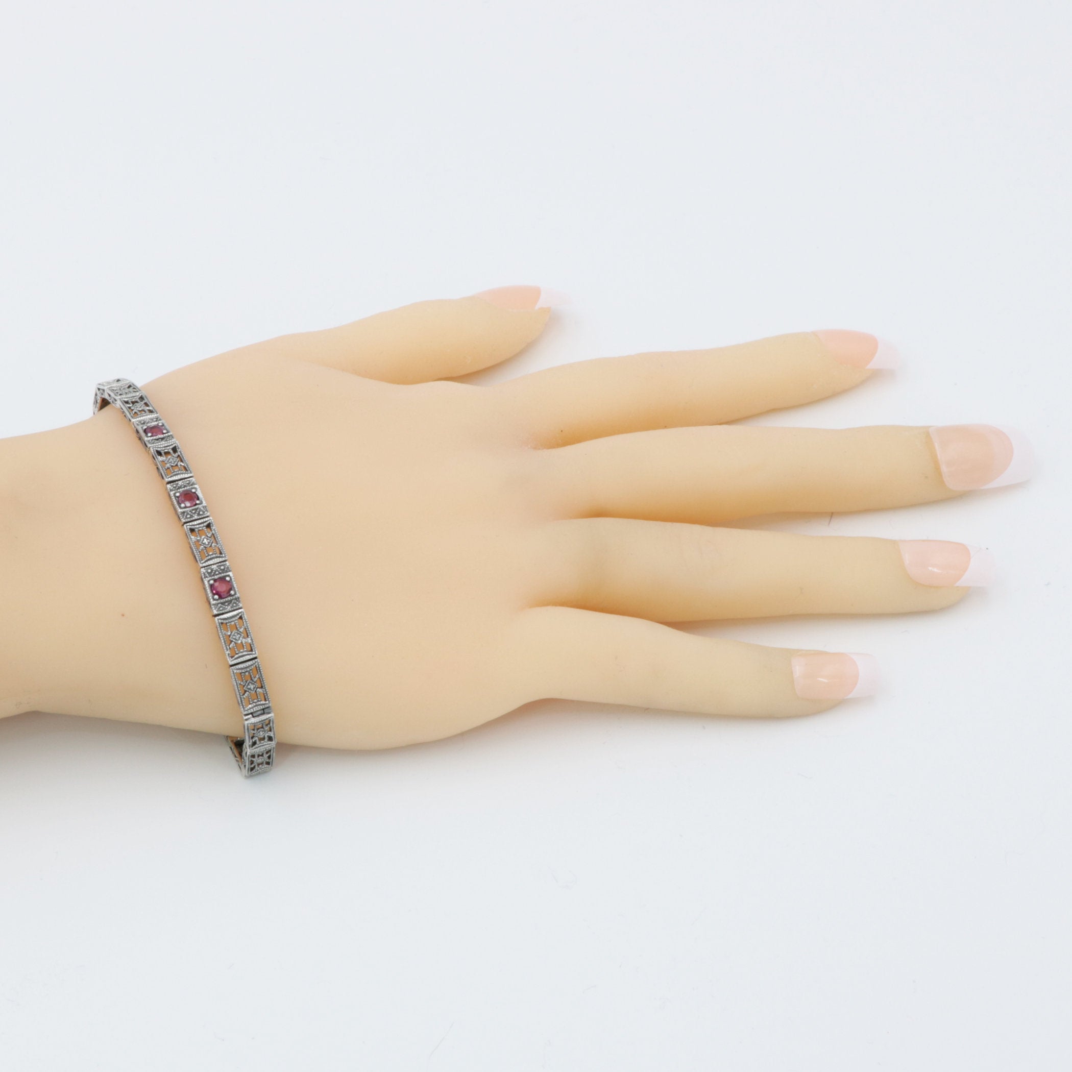 Detail view of Victorian Style 3 Stone Natural Red Ruby Filigree Bracelet in Fine Sterling Silver highlighting Ruby