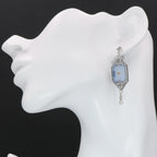 Detail view of Art Deco Style Blue Sunray Crystal Dangle Filigree Earrings Diamond Accent highlighting filigree detail