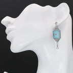 Detail view of Art Deco Style Teal Sunray Crystal Dangle Filigree Earrings Diamond Accent highlighting filigree detail