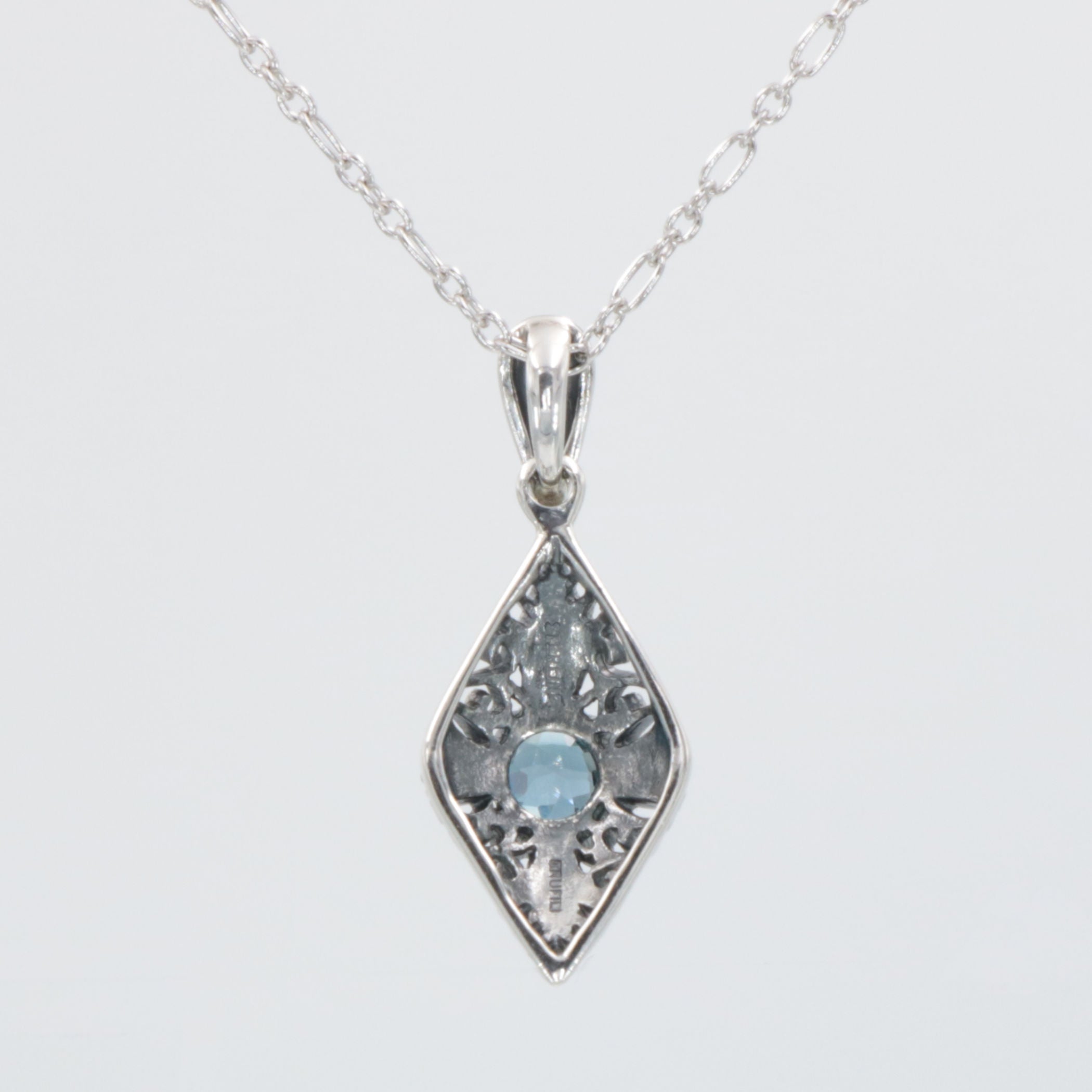 Back view of Art Deco Style London Blue Topaz Filigree Pendant with Chain showing 925 sterling silver hallmark and spring rin