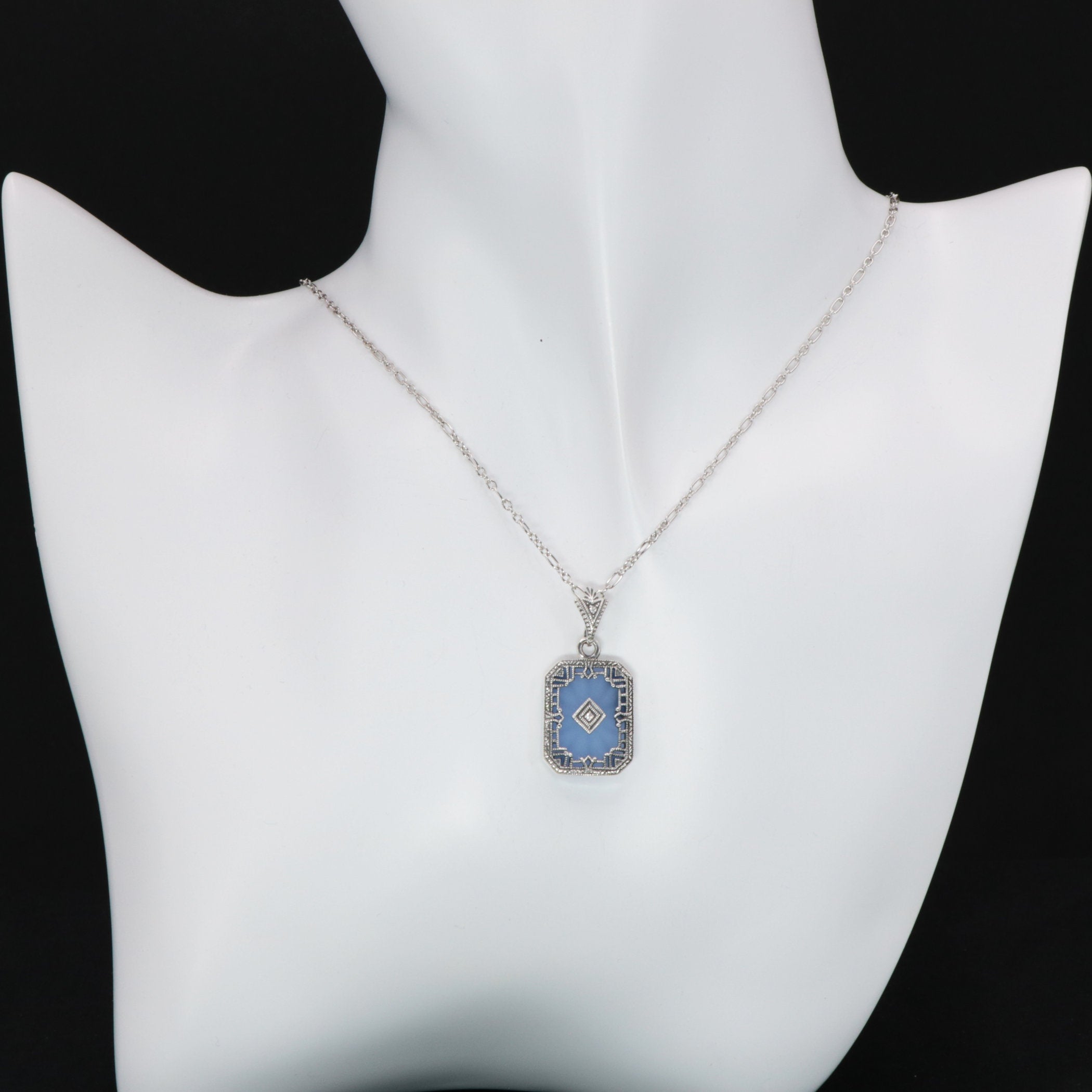 Detail view of Art Deco Style Filigree Pendant Blue Pressed Glass Crystal Diamond Accents Sterling Silver highlighting Diamon