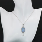 Detail view of Art Deco Style Blue Sunray Crystal Dangle Filigree Pendant Diamond Accent Sterling Silver highlighting Diamond