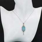 Detail view of Art Deco Style Teal Sunray Crystal Dangle Filigree Pendant Diamond Accent Sterling Silver highlighting Diamond