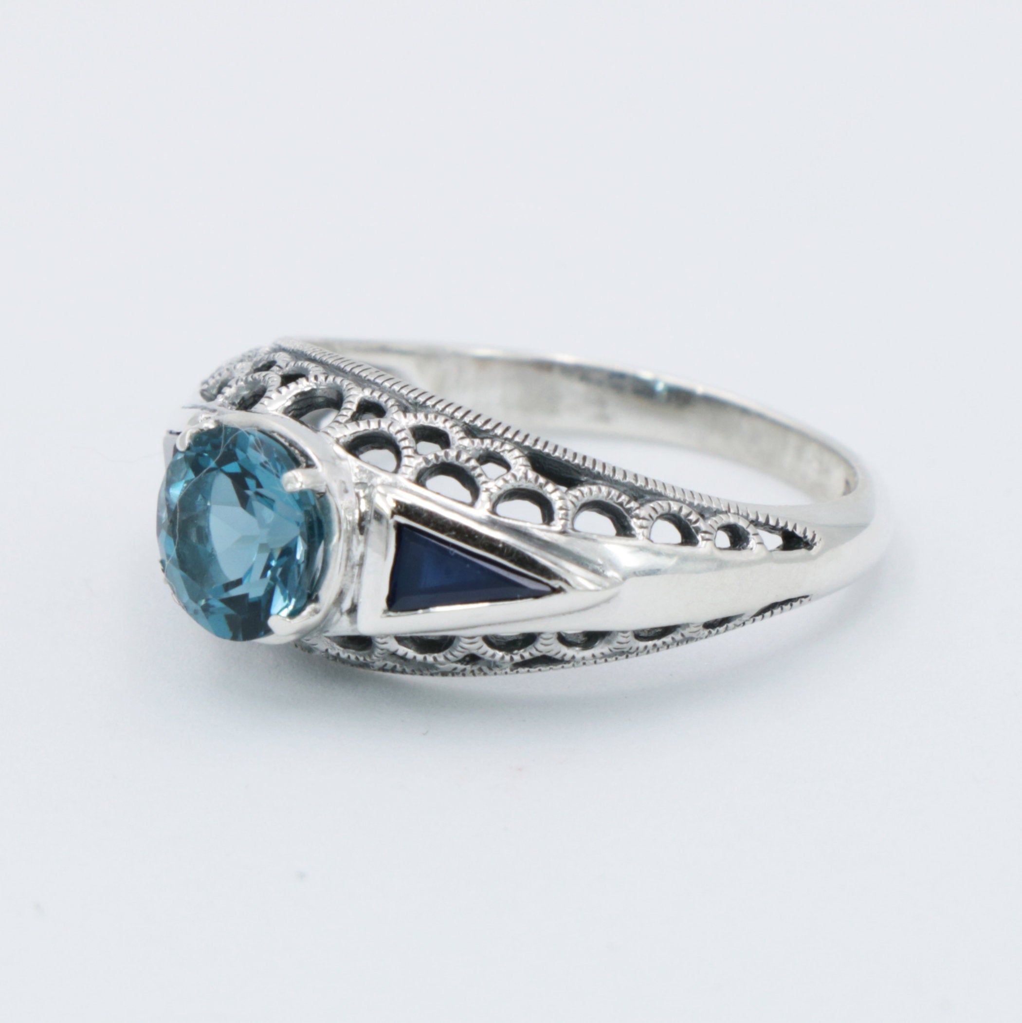 Detail view of Art Deco Filigree London Blue Topaz Ring with Natural Sapphire Accents Sterling Silver highlighting Blue Topaz