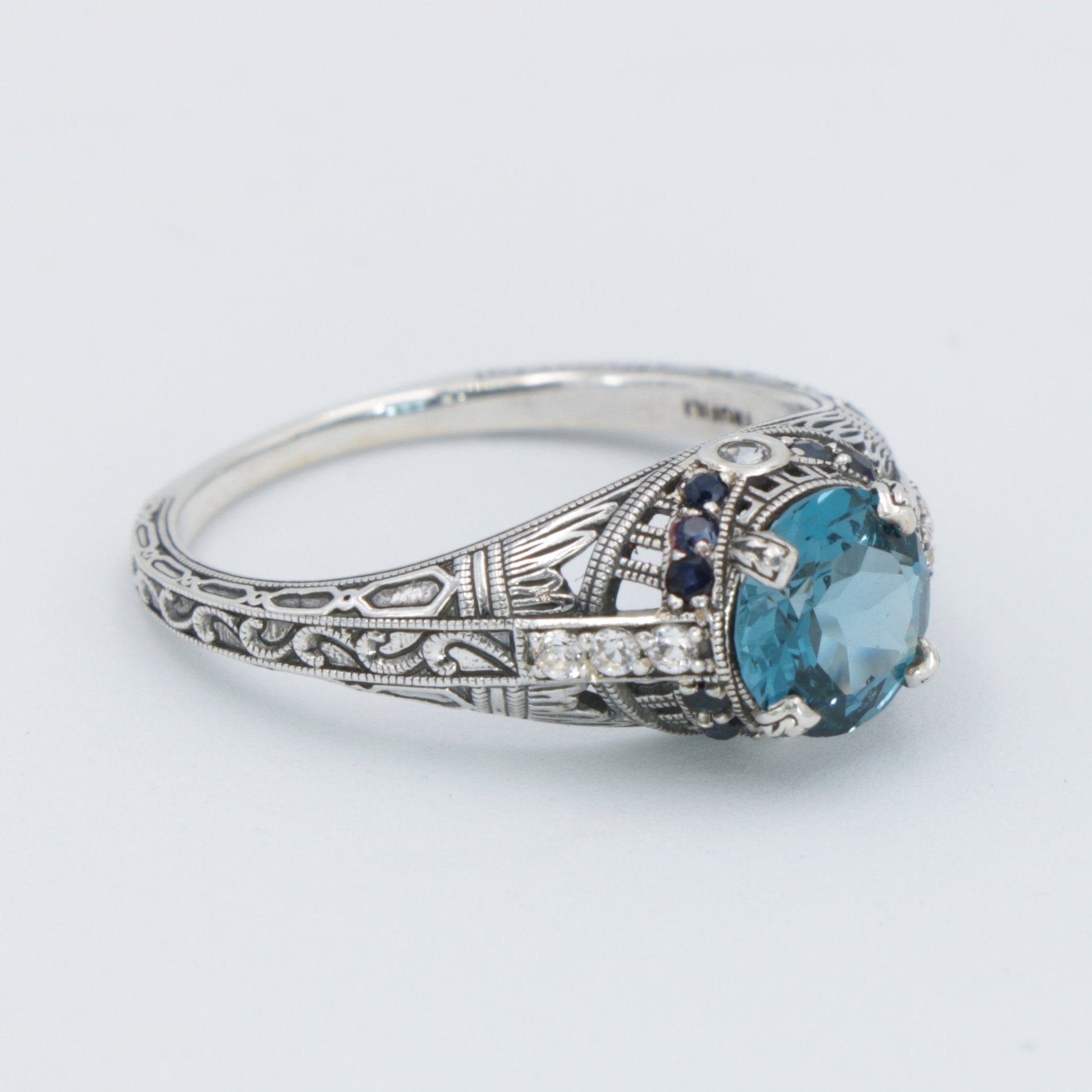 Detail view of Art Deco Style 7mm London Blue Topaz Filigree Ring w/ Sapphire and Topaz accents Sterling Silver highlighting 