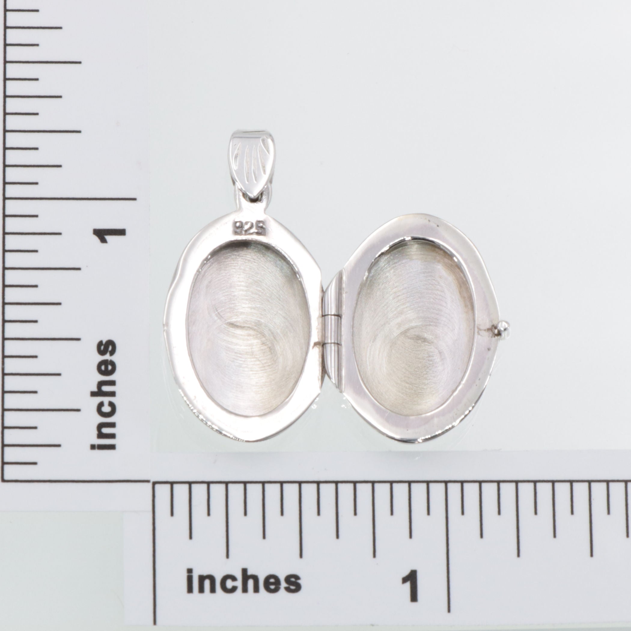 Detail view of Etched Border Design Oval Locket - Engravable highlighting design details
