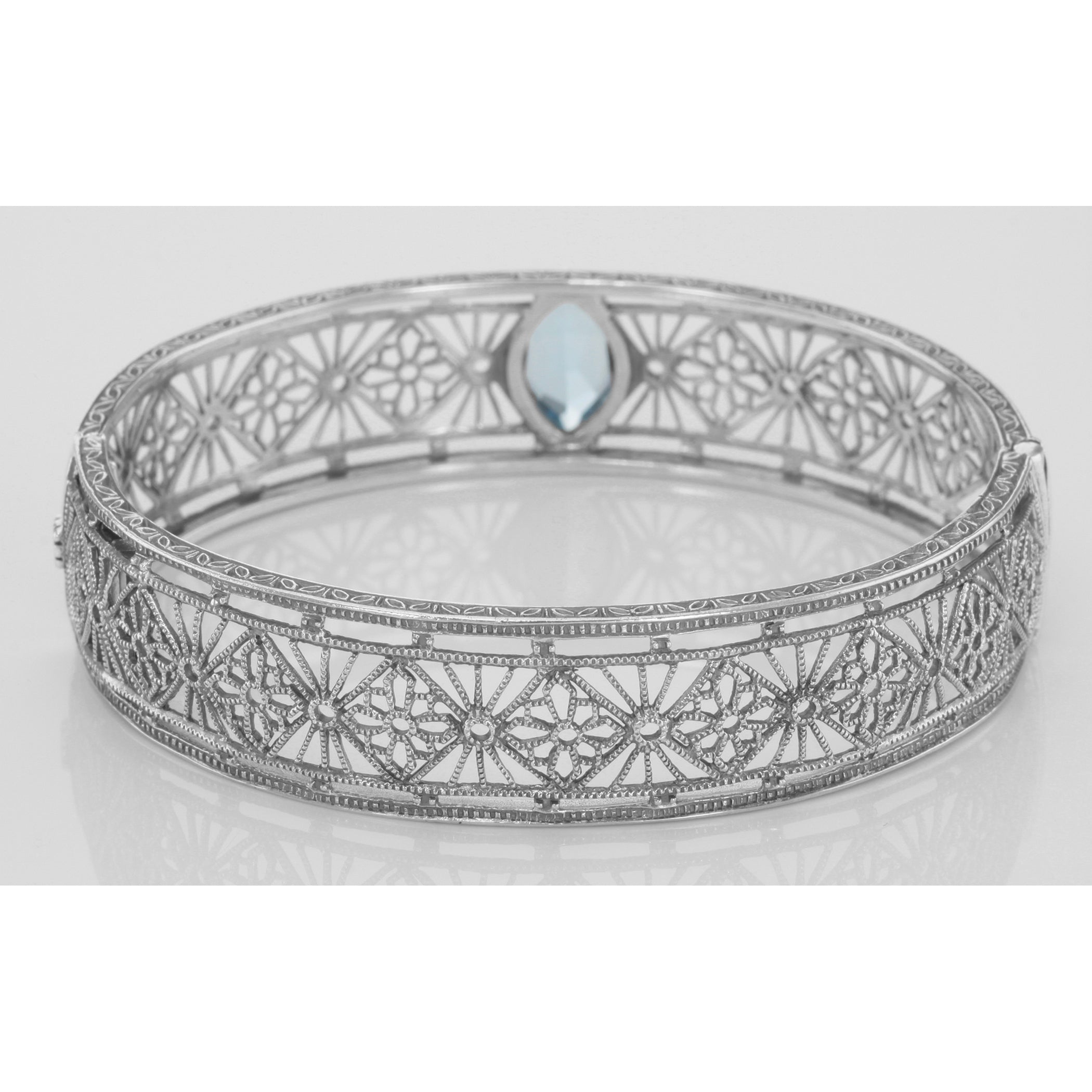 Detail view of Victorian Style Filigree Blue Topaz Bangle Bracelet In Fine Sterling Silver highlighting Blue Topaz