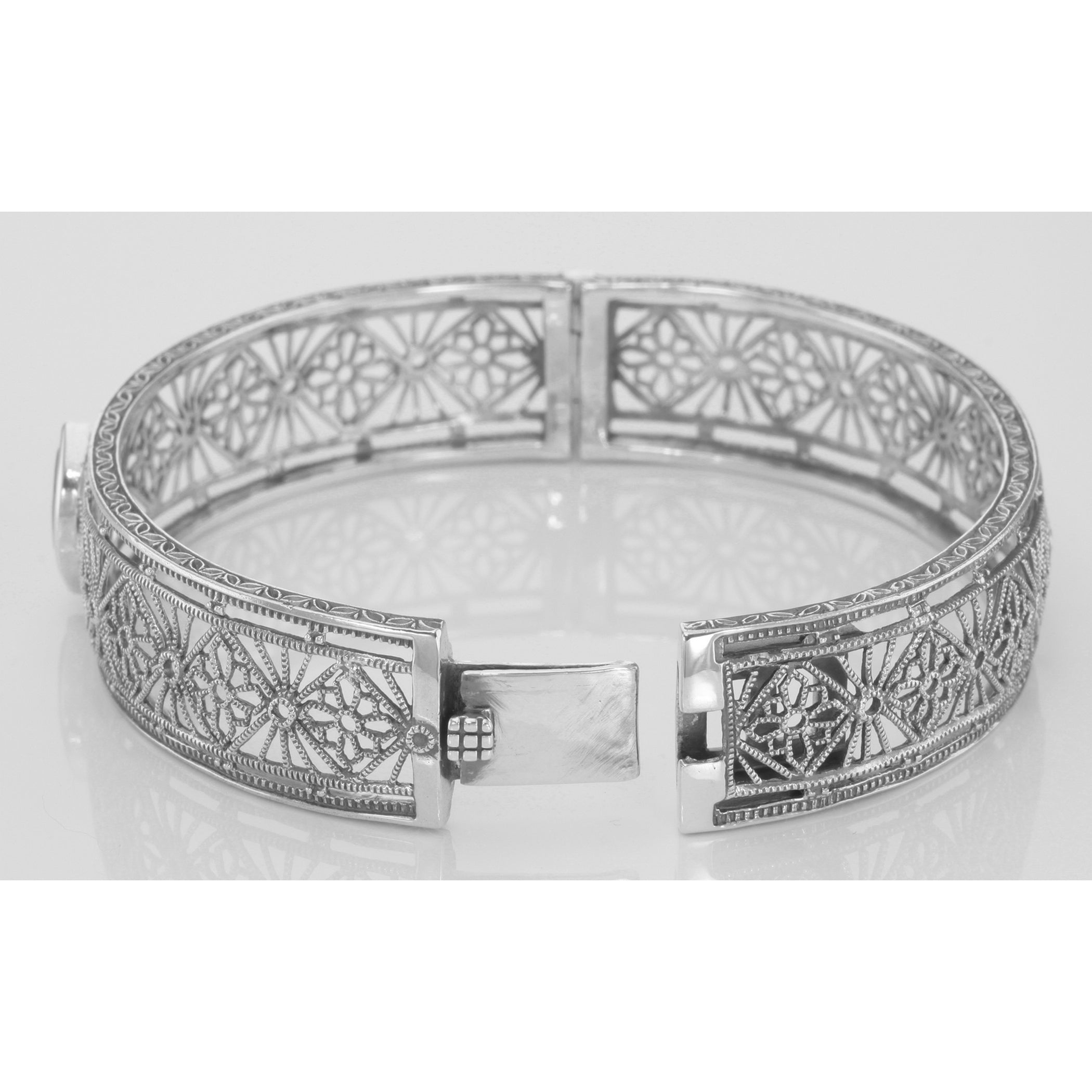 Back view of Victorian Style Filigree Blue Topaz Bangle Bracelet In Fine Sterling Silver showing 925 sterling silver hallmark