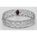 Detail view of Victorian Style Filigree Garnet Bangle Bracelet In Fine Sterling Silver highlighting Garnet