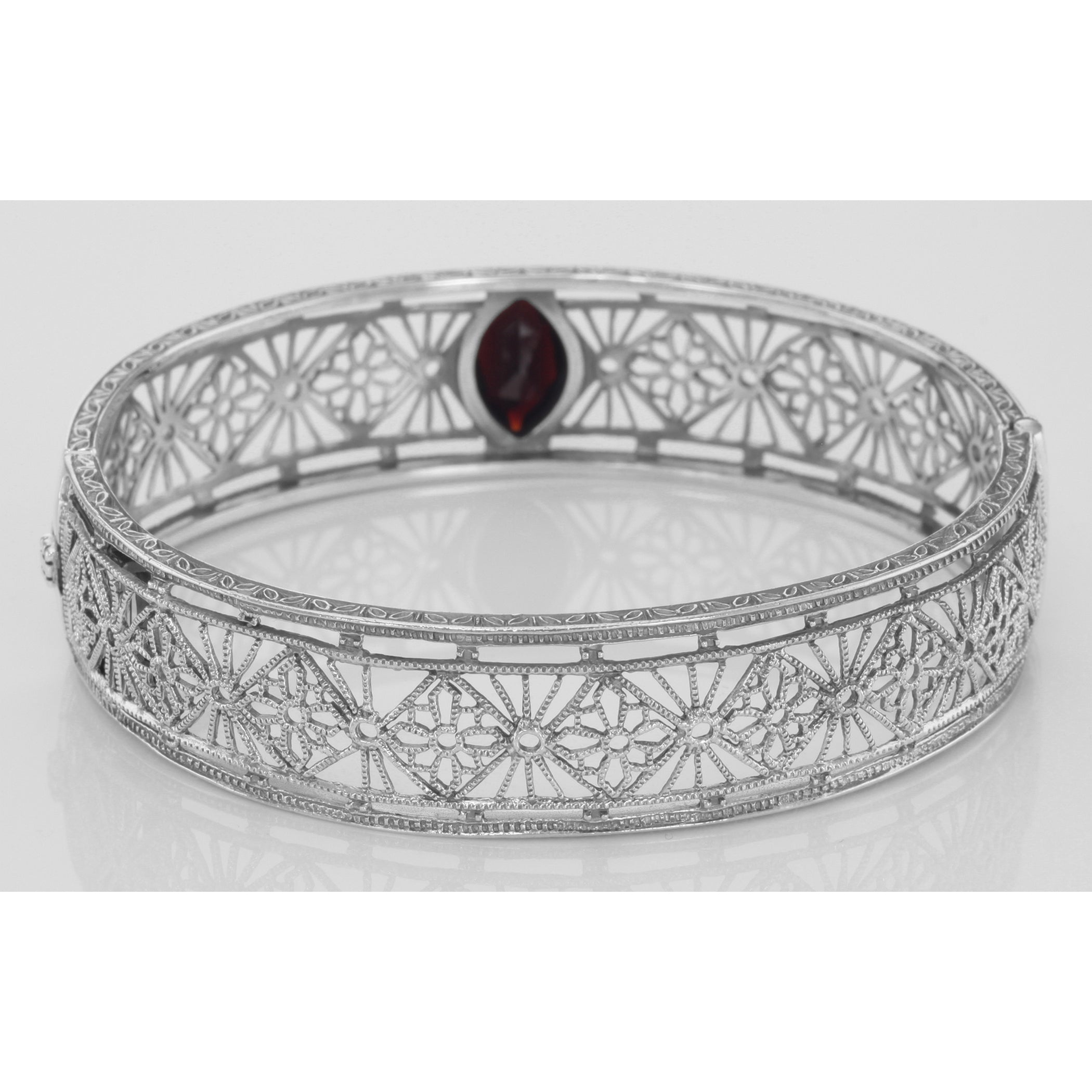 Detail view of Victorian Style Filigree Garnet Bangle Bracelet In Fine Sterling Silver highlighting Garnet