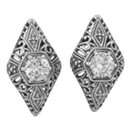 Art Deco diamond-shaped filigree stud earrings, round white topaz prong set, ornate scrollwork surround, sterling silver