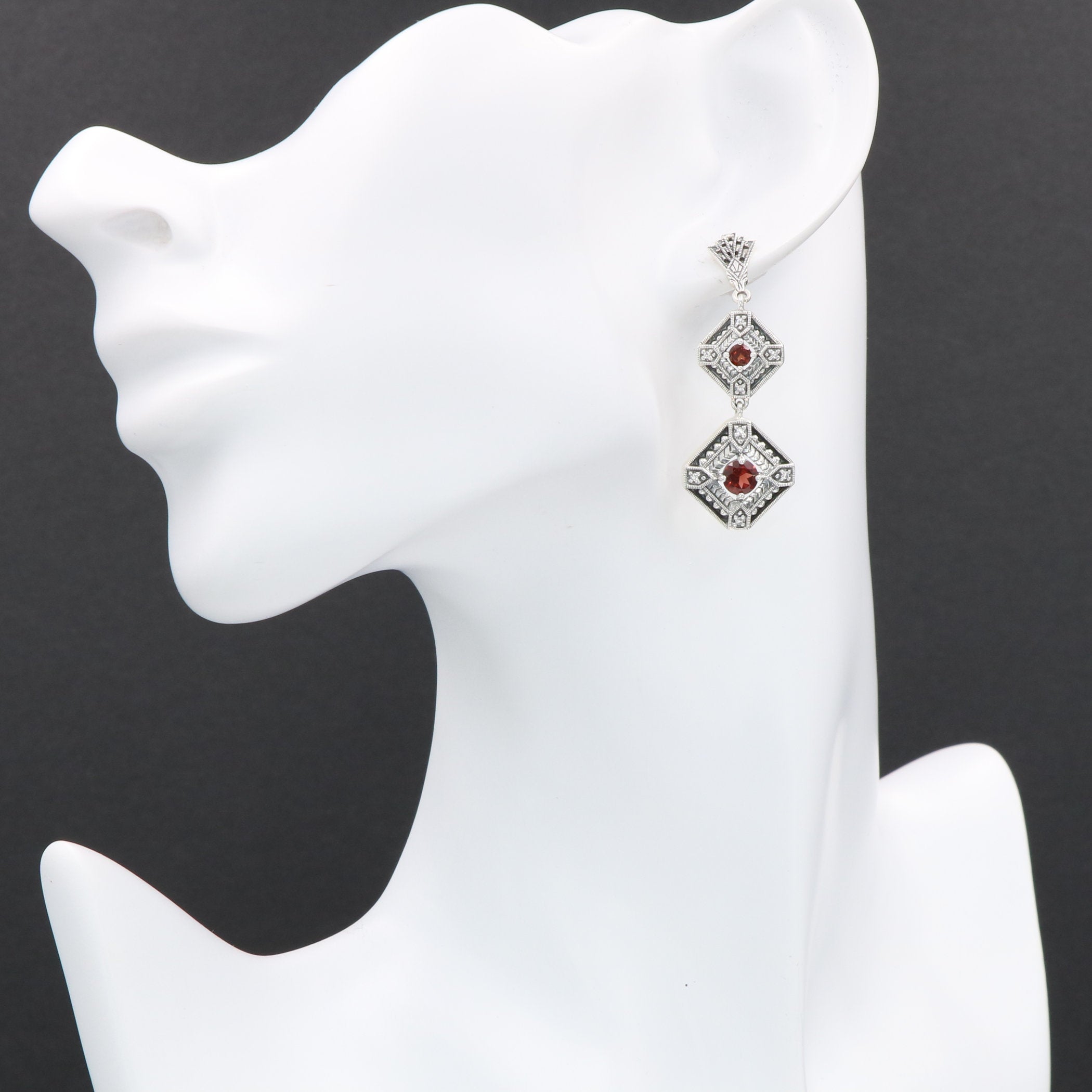 Detail view of Art Deco Style Garnet Two Tiered Earrings highlighting garnet detail
