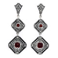 Art Deco two-tiered dangle earrings, red garnet rounds in diamond filigree frames, diamond accents, fan post, sterling silver