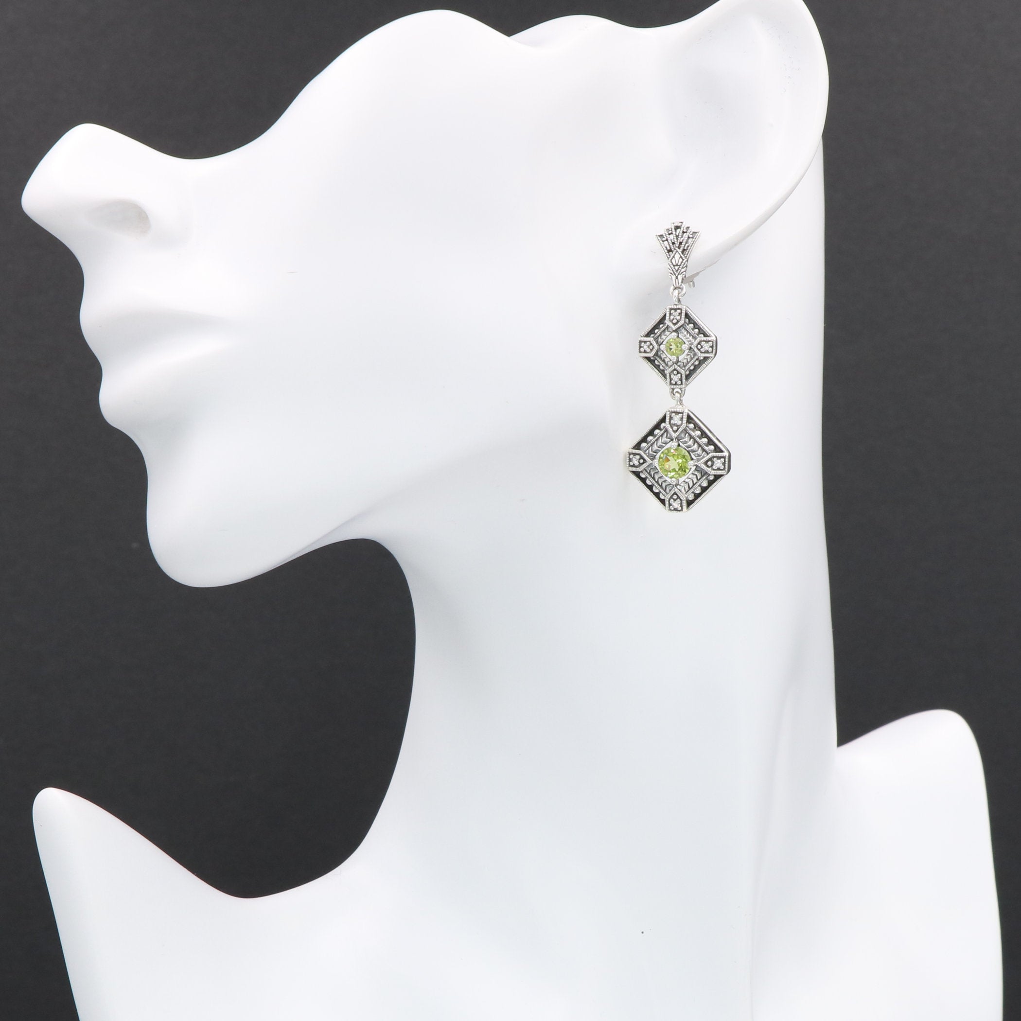Detail view of Art Deco Style Peridot Two Tiered Earrings highlighting craftsmanship detail