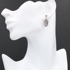 Detail view of Art Deco Genuine Ruby and White Topaz Filigree Earrings highlighting filigree detail