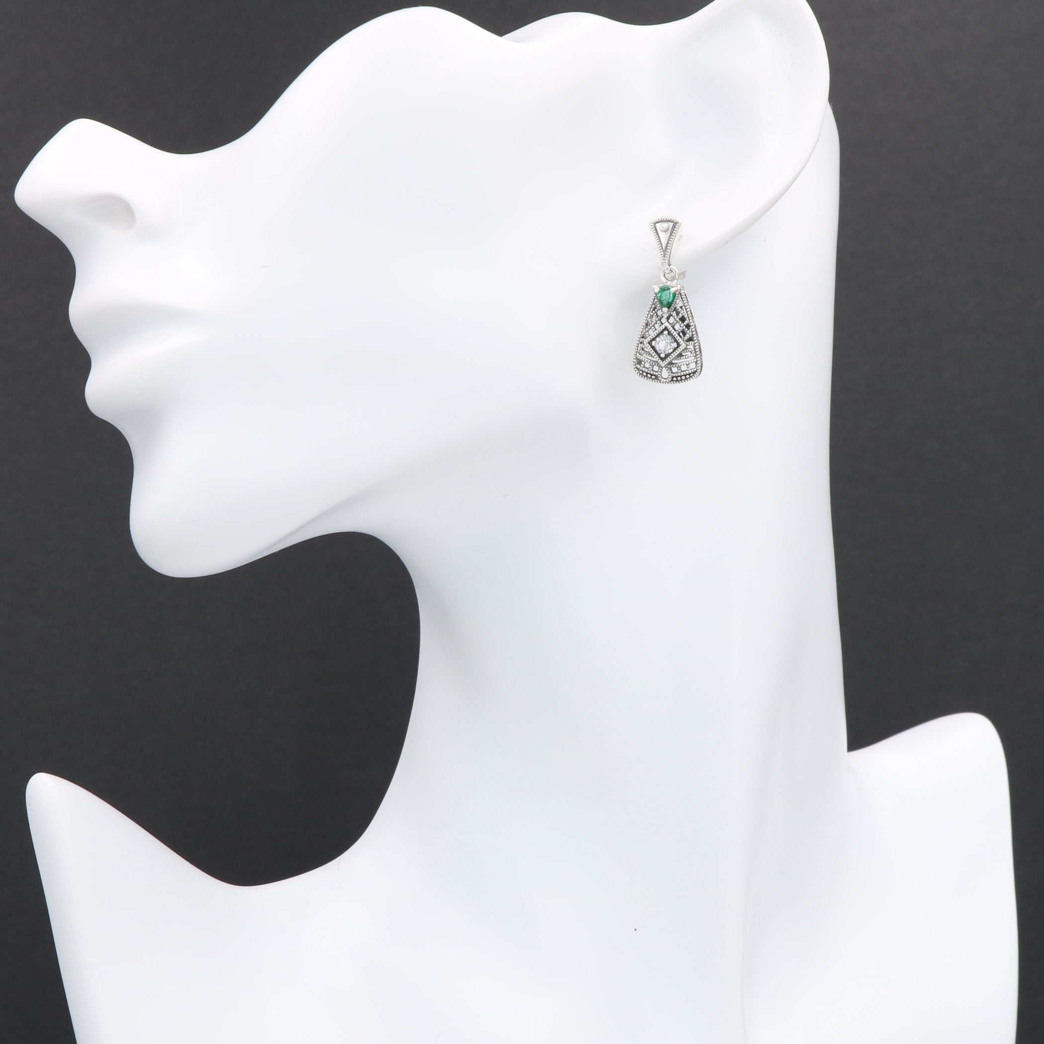 Detail view of Art Deco Emerald and White Topaz Filigree Earrings highlighting filigree detail