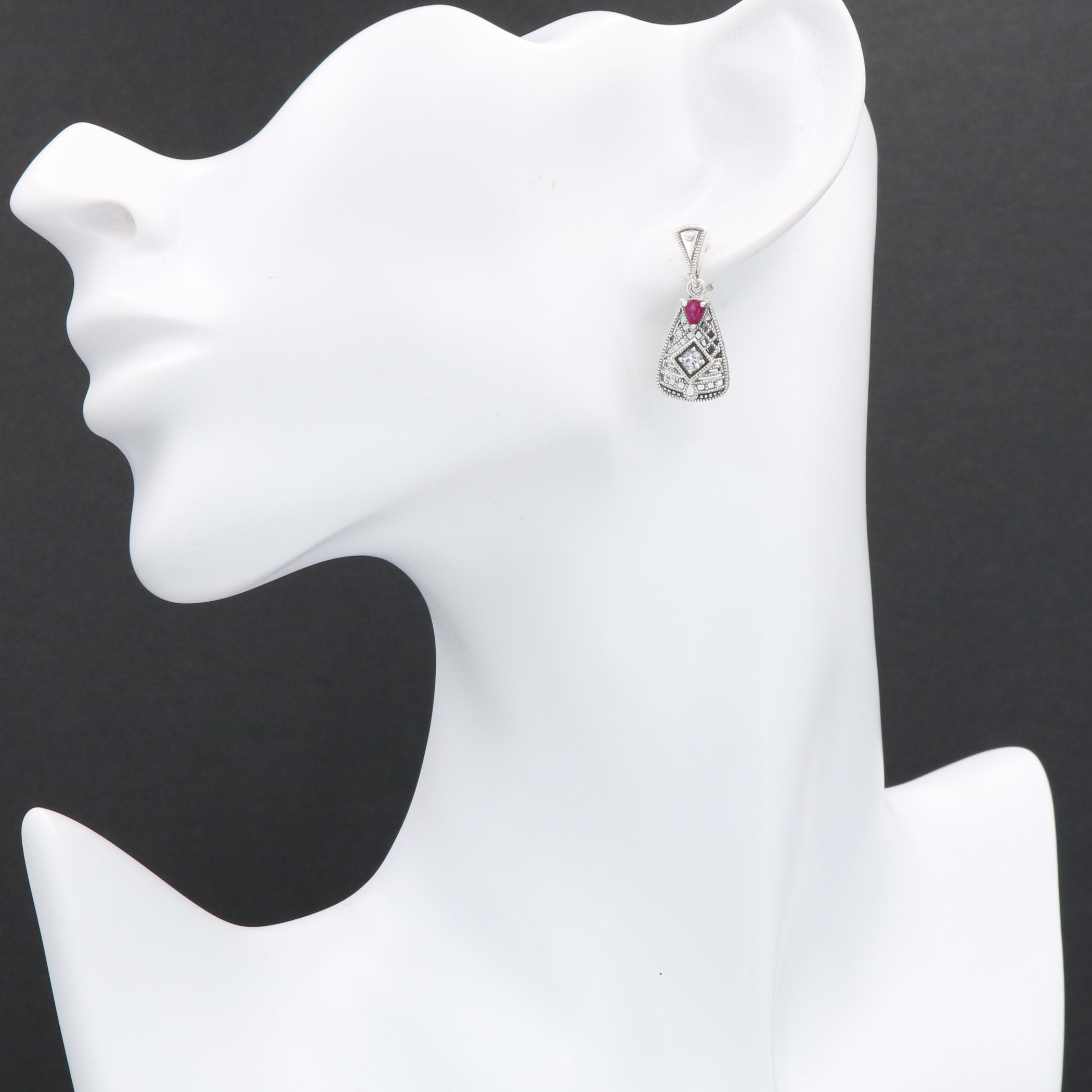 Detail view of Art Deco Style Ruby and White Topaz Filigree Earrings highlighting filigree detail