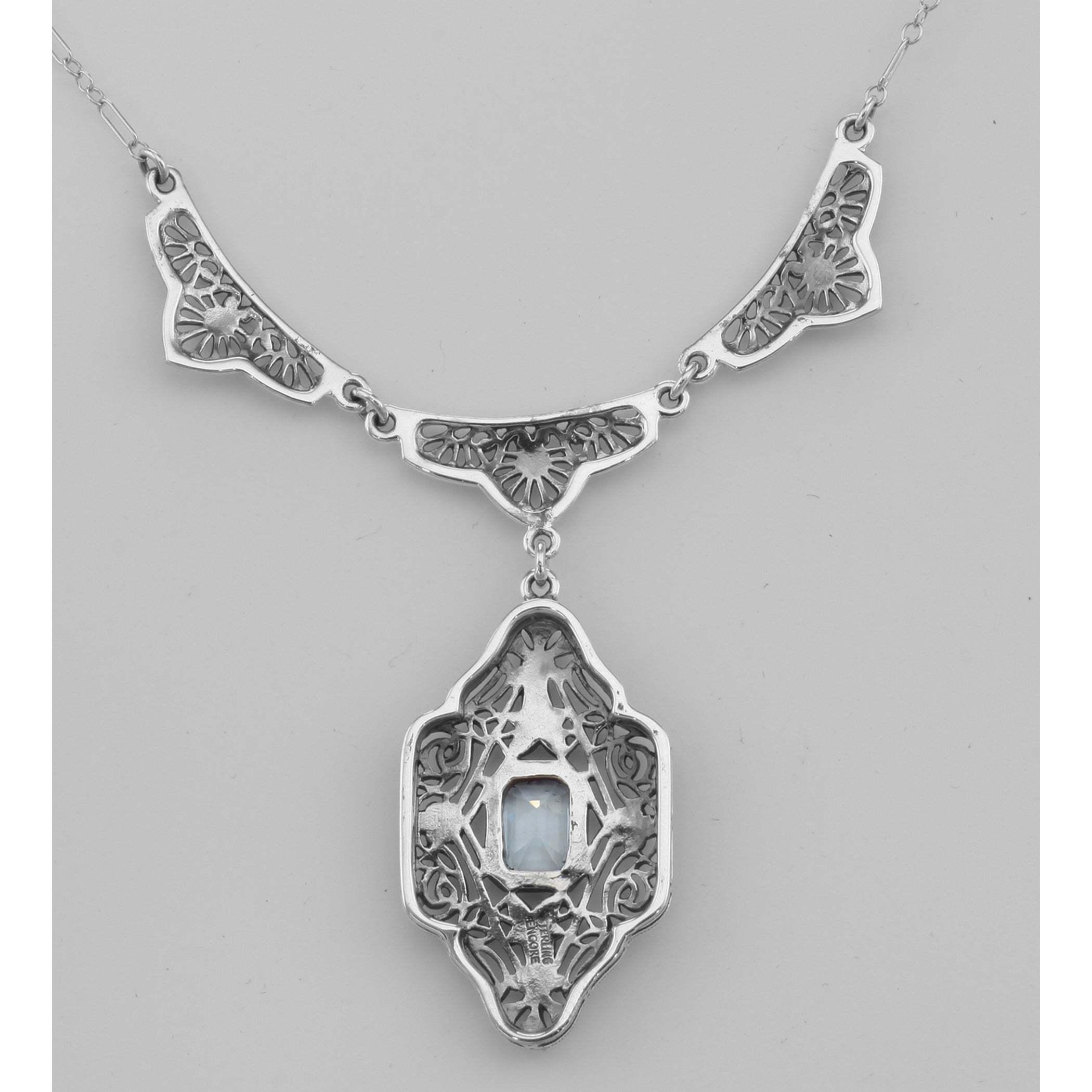 Back view of Unique Victorian Style Blue Topaz Filigree Necklace showing 925 sterling silver hallmark and spring ring clasp