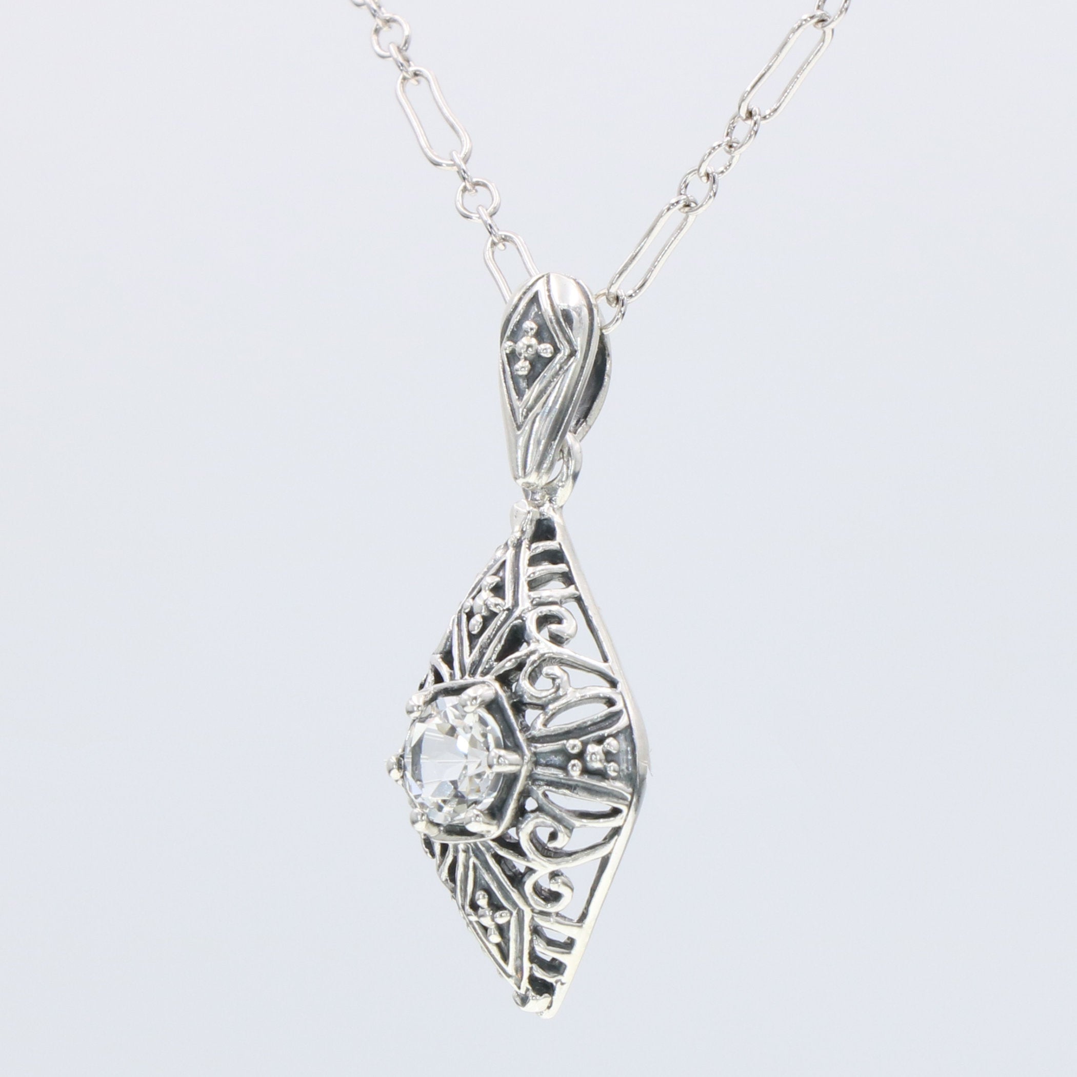 Detail view of Victorian Style White Topaz Filigree Pendant with Chain highlighting White Topaz