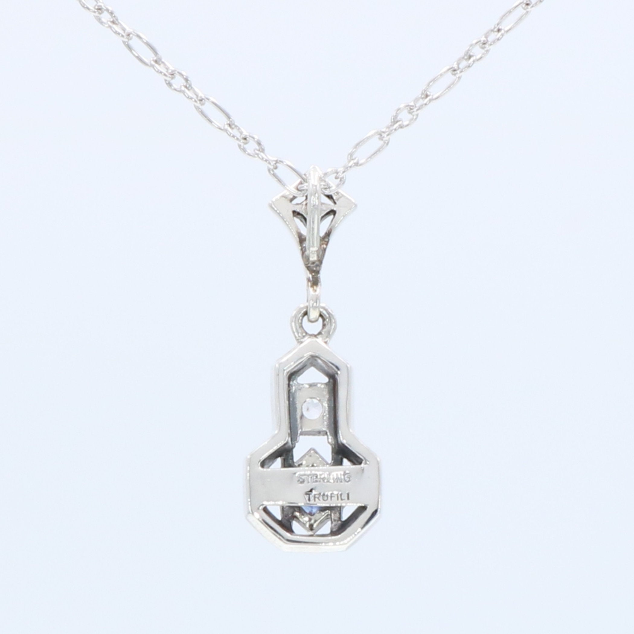 Back view of Sapphire and White Topaz Filigree Pendant showing 925 sterling silver hallmark and spring ring clasp