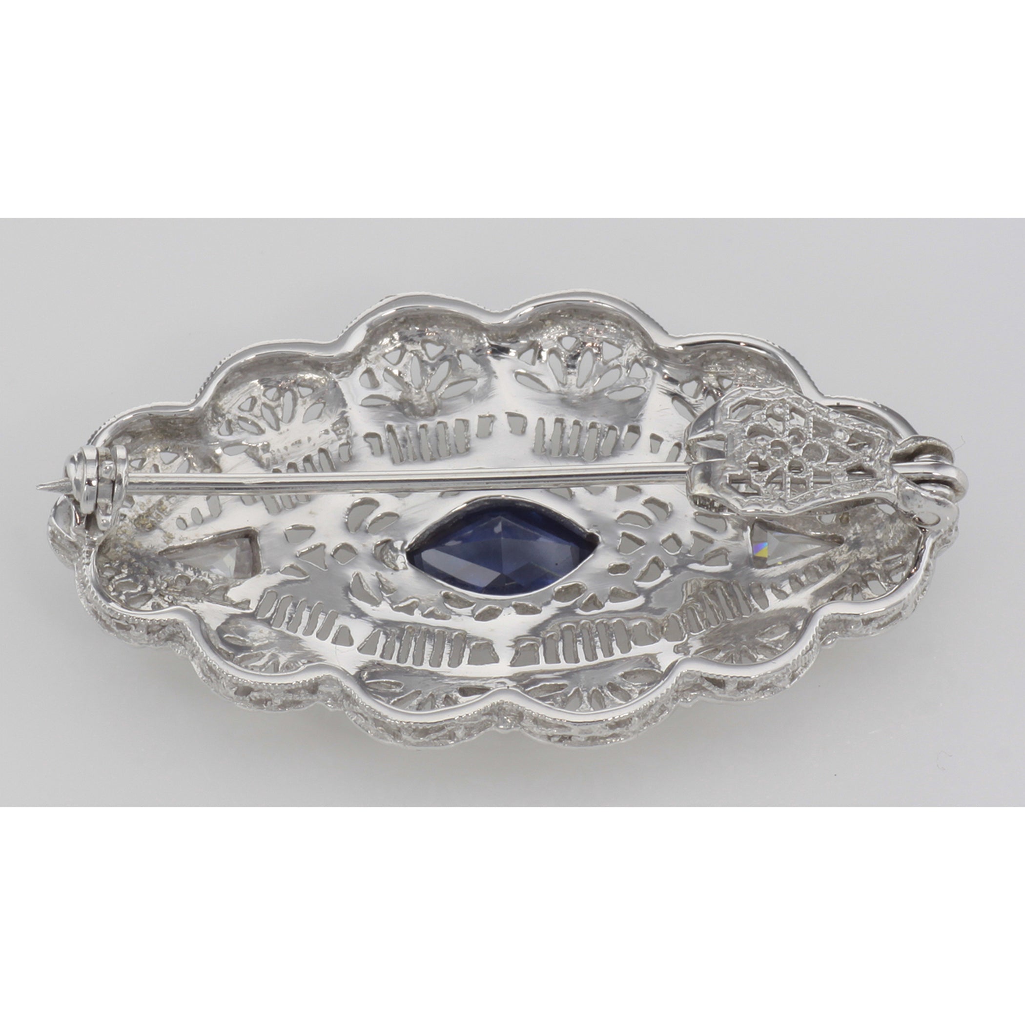 Detail view of Beautiful Syn Blue Sapphire Filigree Pin / Brooch or Pendant Sterling Silver highlighting Sapphire