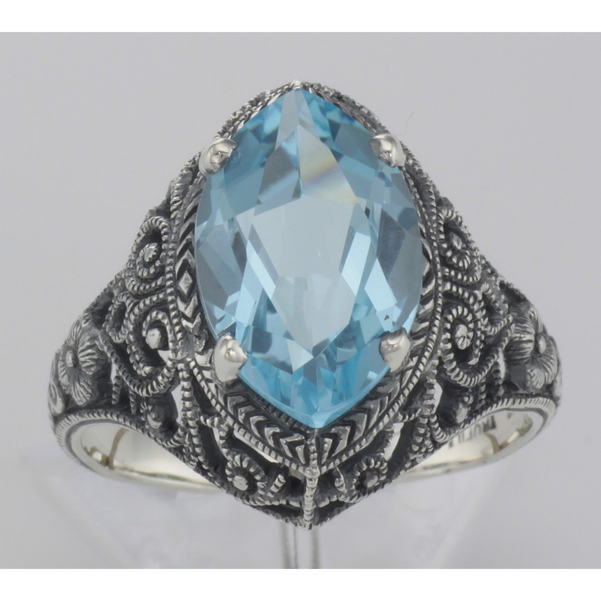 Detail view of Beautiful 3 Carat Victorian Style Blue Topaz Filigree Ring Sterling Silver highlighting Blue Topaz