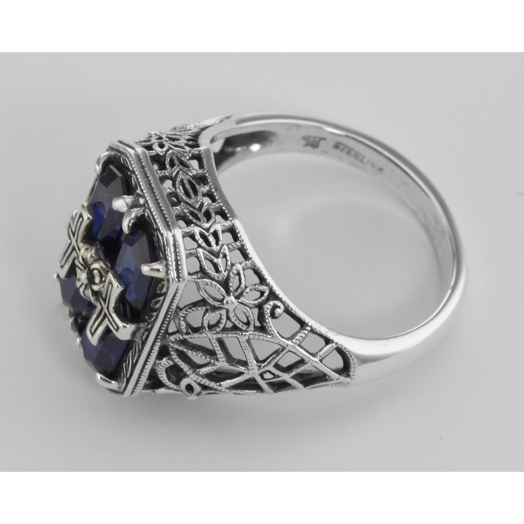 Back view of Cross and Flower Design Blue Sapphire Filigree Ring showing 925 sterling silver hallmark