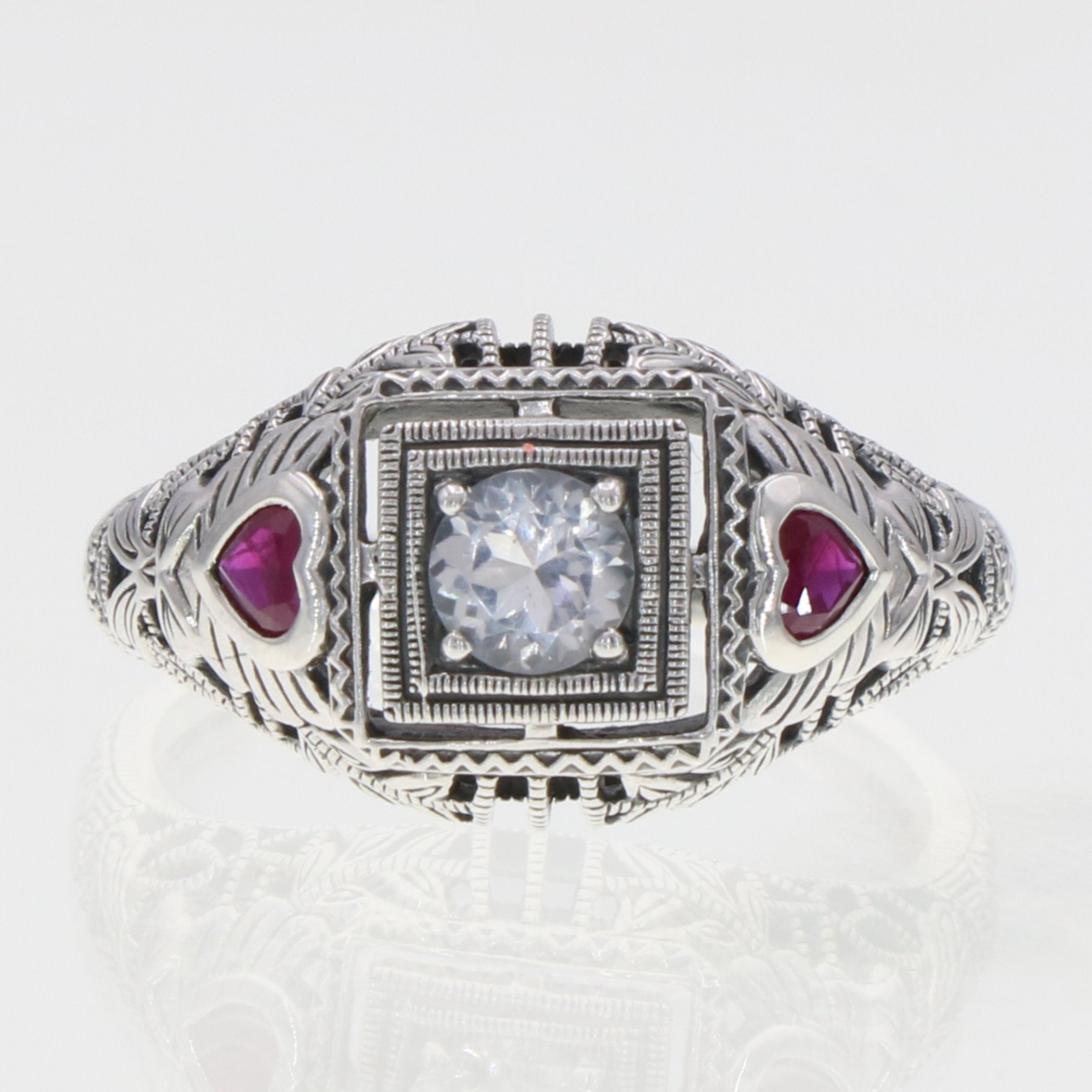 Detail view of Art Deco Style White Topaz Filigree Ring Red Ruby Accents Sterling Silver highlighting White Topaz, Ruby