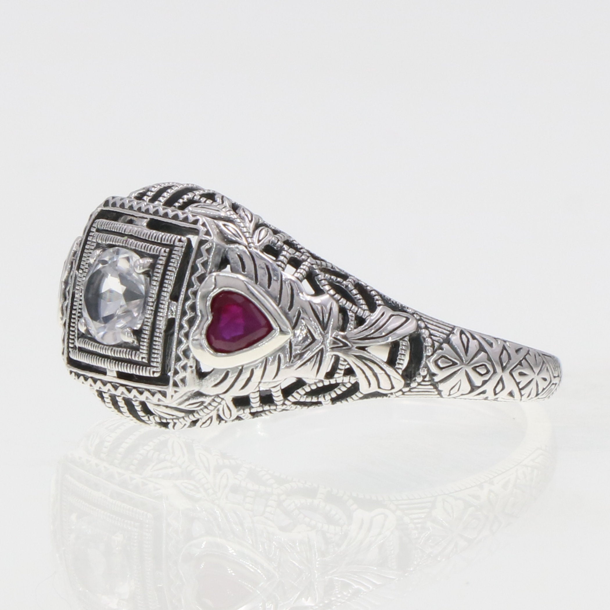 Back view of Art Deco Style White Topaz Filigree Ring Red Ruby Accents Sterling Silver showing 925 sterling silver hallmark