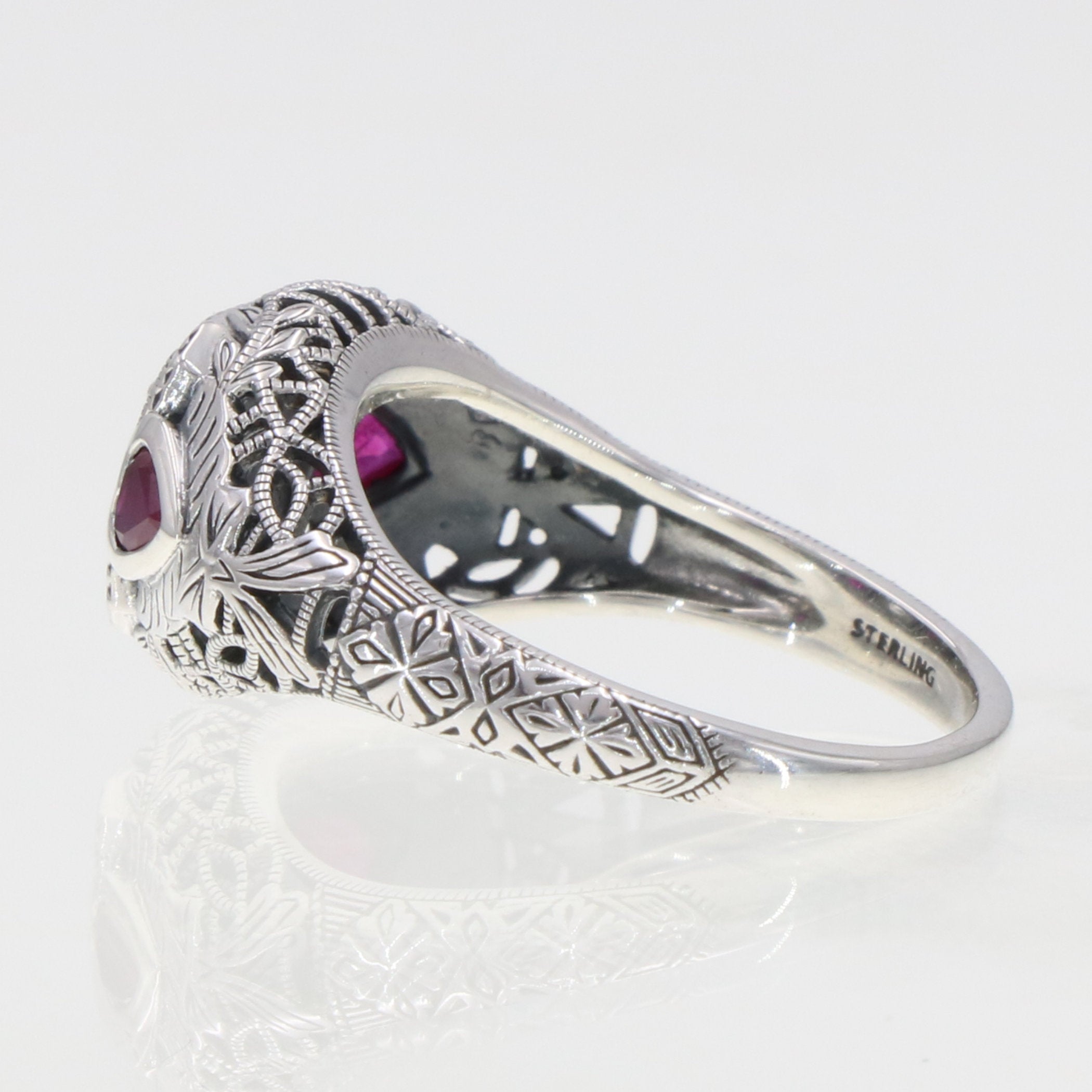 Detail view of Art Deco Style White Topaz Filigree Ring Red Ruby Accents Sterling Silver highlighting White Topaz, Ruby