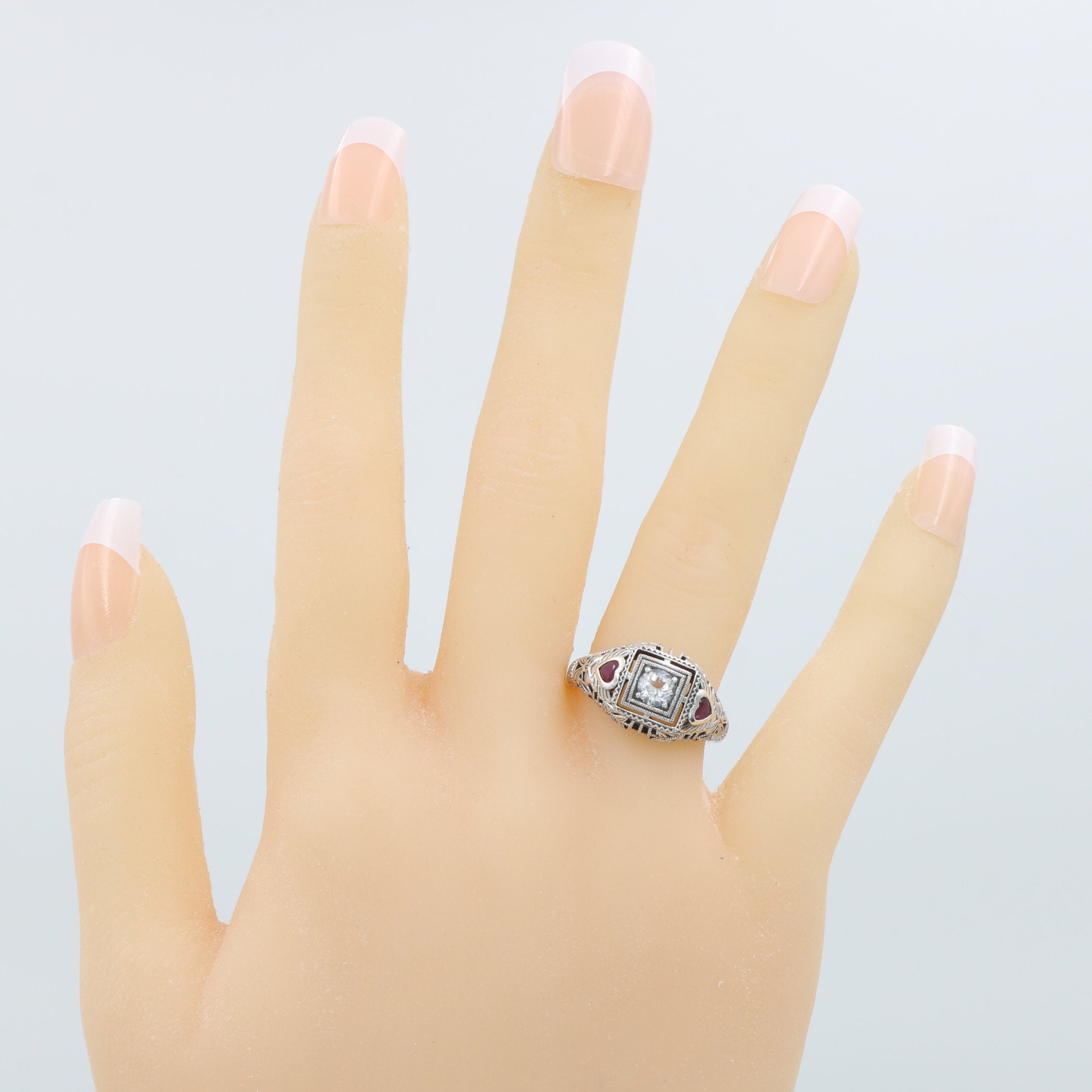 Detail view of Art Deco Style White Topaz Filigree Ring Red Ruby Accents Sterling Silver highlighting White Topaz, Ruby