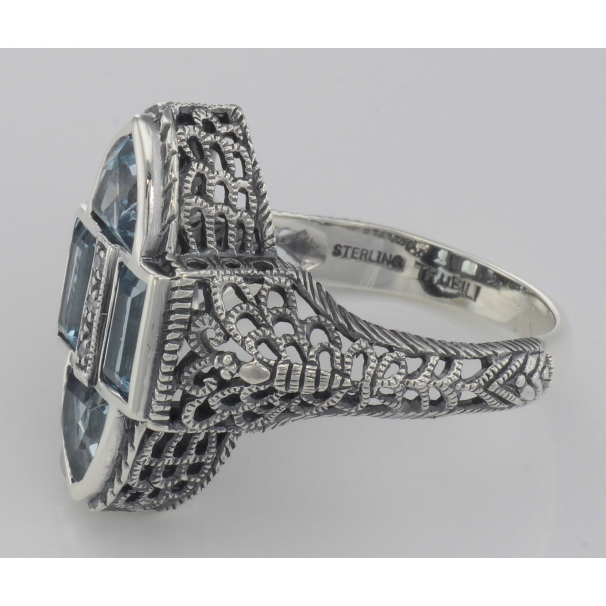 Back view of Antique Style Four Stone Blue Topaz and Diamond Ring showing 925 sterling silver hallmark