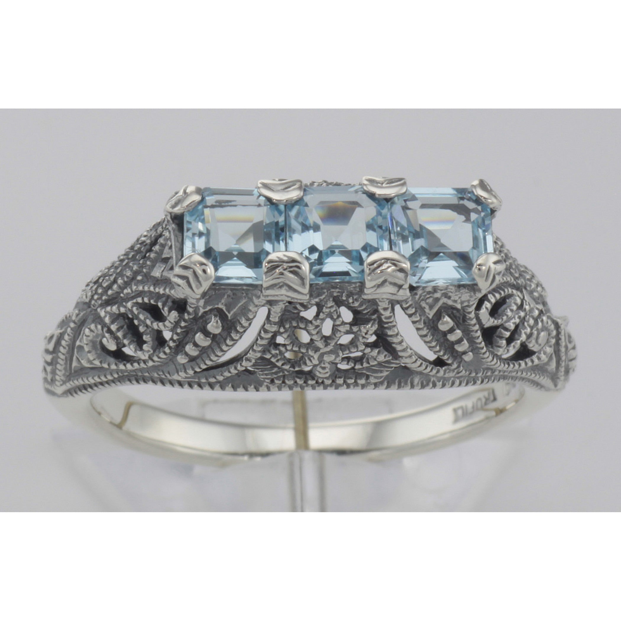 Detail view of Art Deco Sterling Silver Filigree Ring 3 Princess Cut Blue Topaz Gems highlighting Blue Topaz