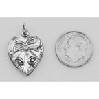 Back view of Heart Pendant Charm with Bells showing 925 sterling silver hallmark and spring ring clasp