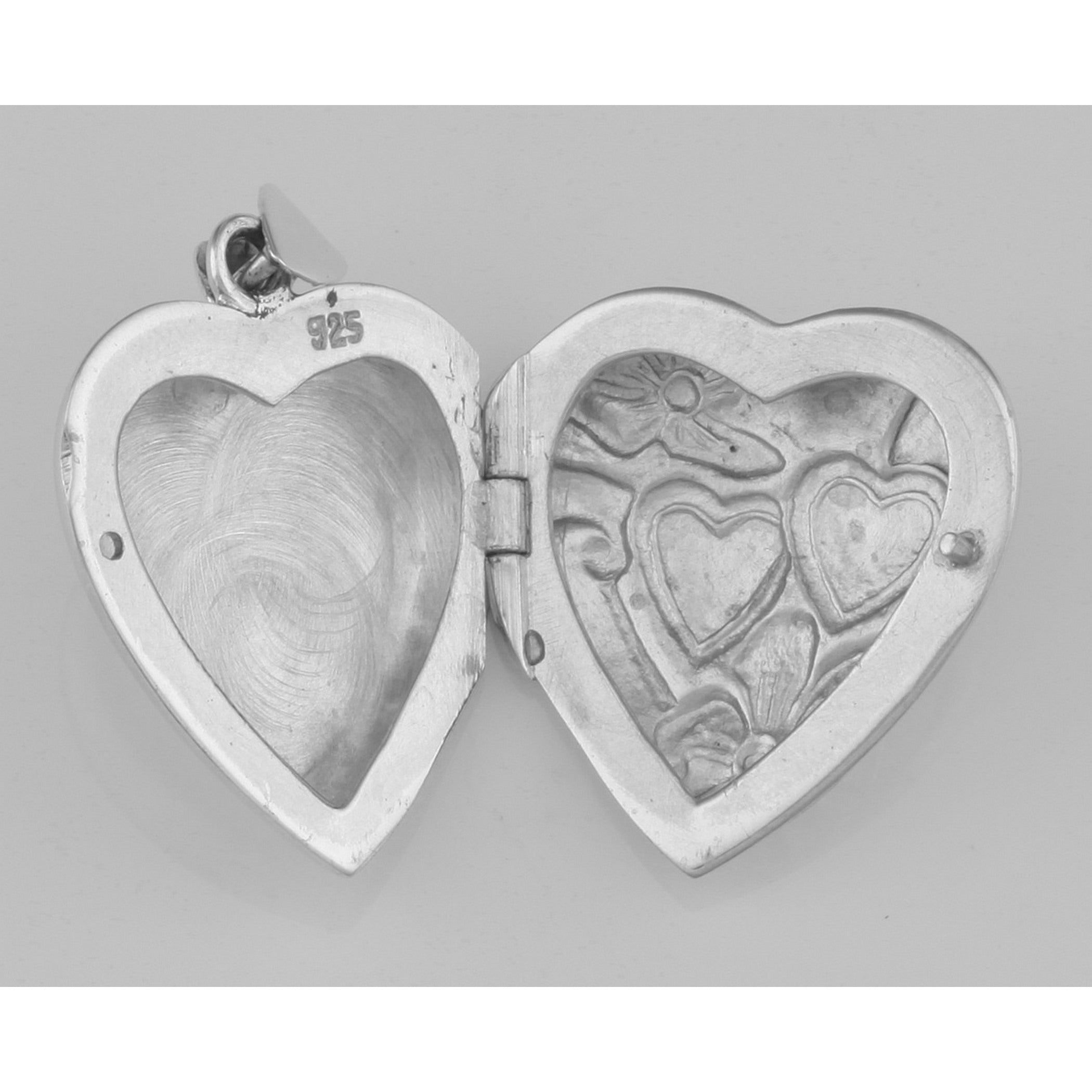Detail view of Vintage Style Interlocking Heart Locket Pendant In Fine Sterling Silver highlighting design details